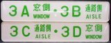 画像: 座席番号プレート（緑文字）　「３A　窓側　・　３B　通路側」・「３C　通路側　・　３D　窓側」